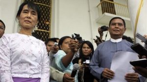 Daw Aung San Suu Kyi and U Aung Kyi listen to questions from the media during a press conference on Aug. 12. (Photo: AP)