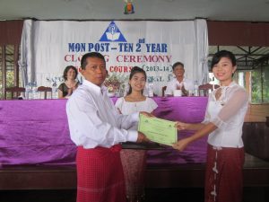 A graduate receives a certificate from Mon National Education Department official Nai Aie Kon during the Post Ten graduation ceremony. (photo: BNA)