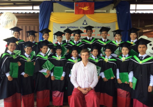 Bop Htaw graduates in group photo with their teacher at graduation ceremony (Photo: Bop Htaw) 